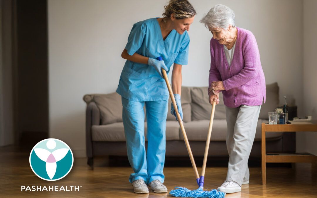 Pasha Health Caregiver and senior cleaning the floor together.