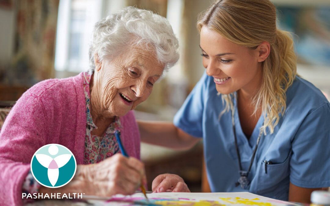 A Pasha Health Care Provider and senior client working on an art project together.
