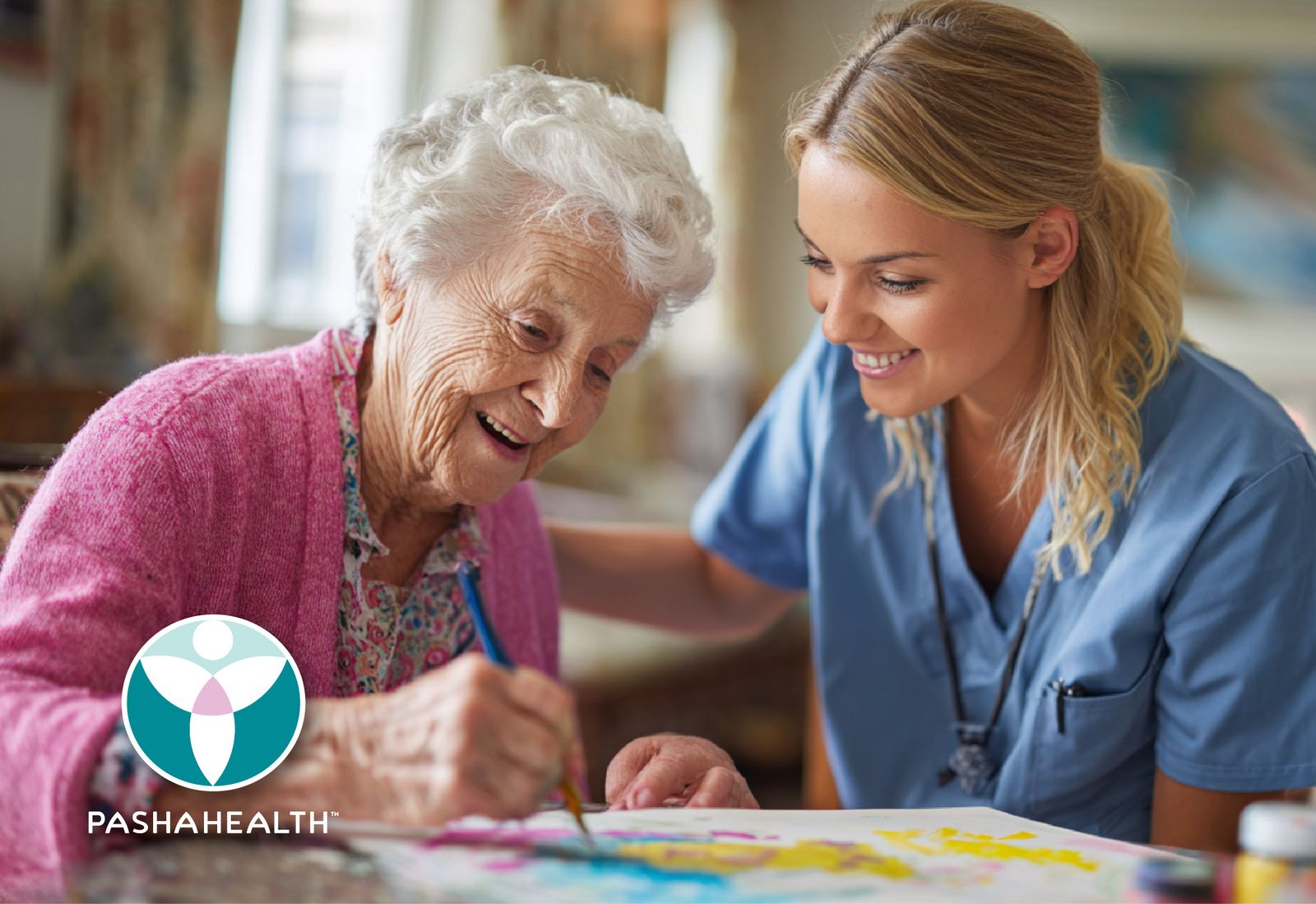 A Pasha Health care provider and senior client working on an art project together