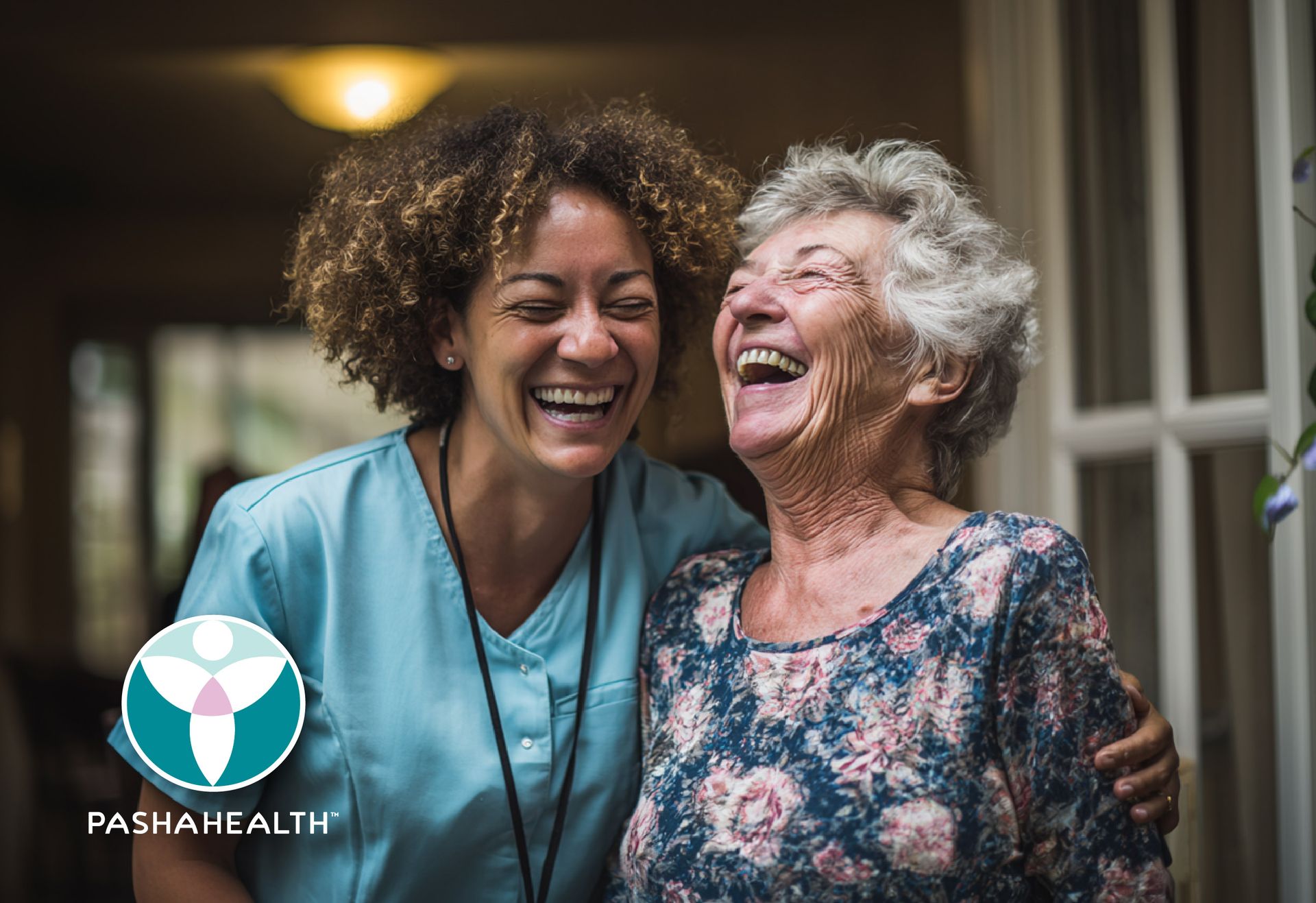 A Pasha Health caregiver and a senior client laughing together