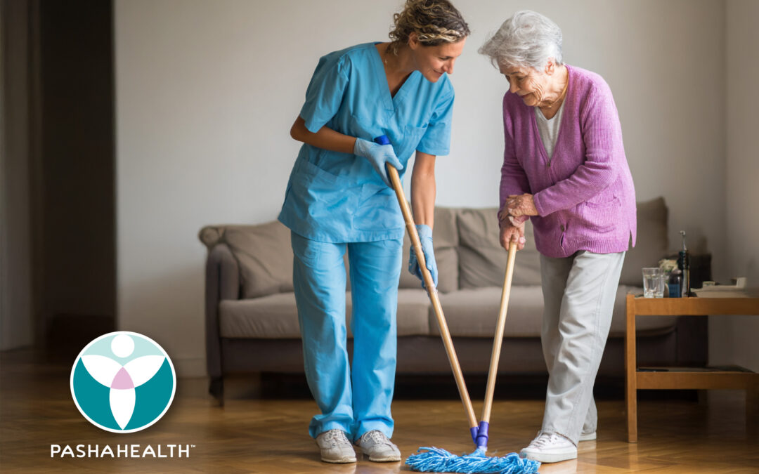 Pasha Health Caregiver and senior cleaning the floor together.